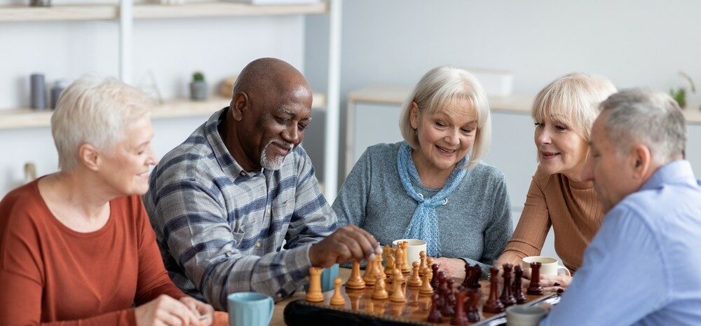 Seniors socializing and playing chess together