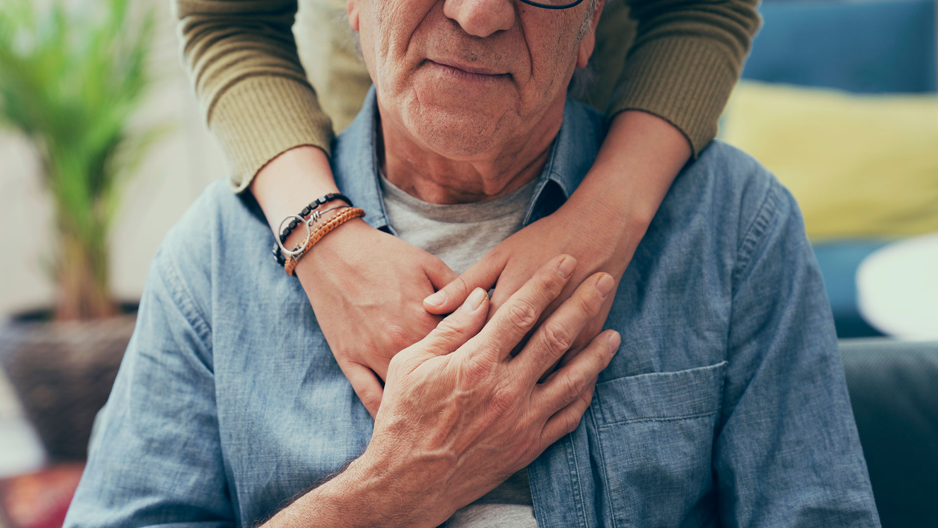 Senior man with dementia being comforted by his caregiver