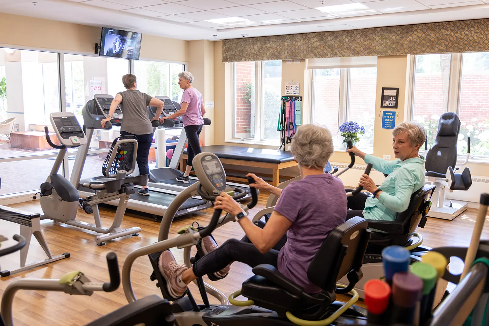 Residents working out in the Fitness Center at Lake Forest Place