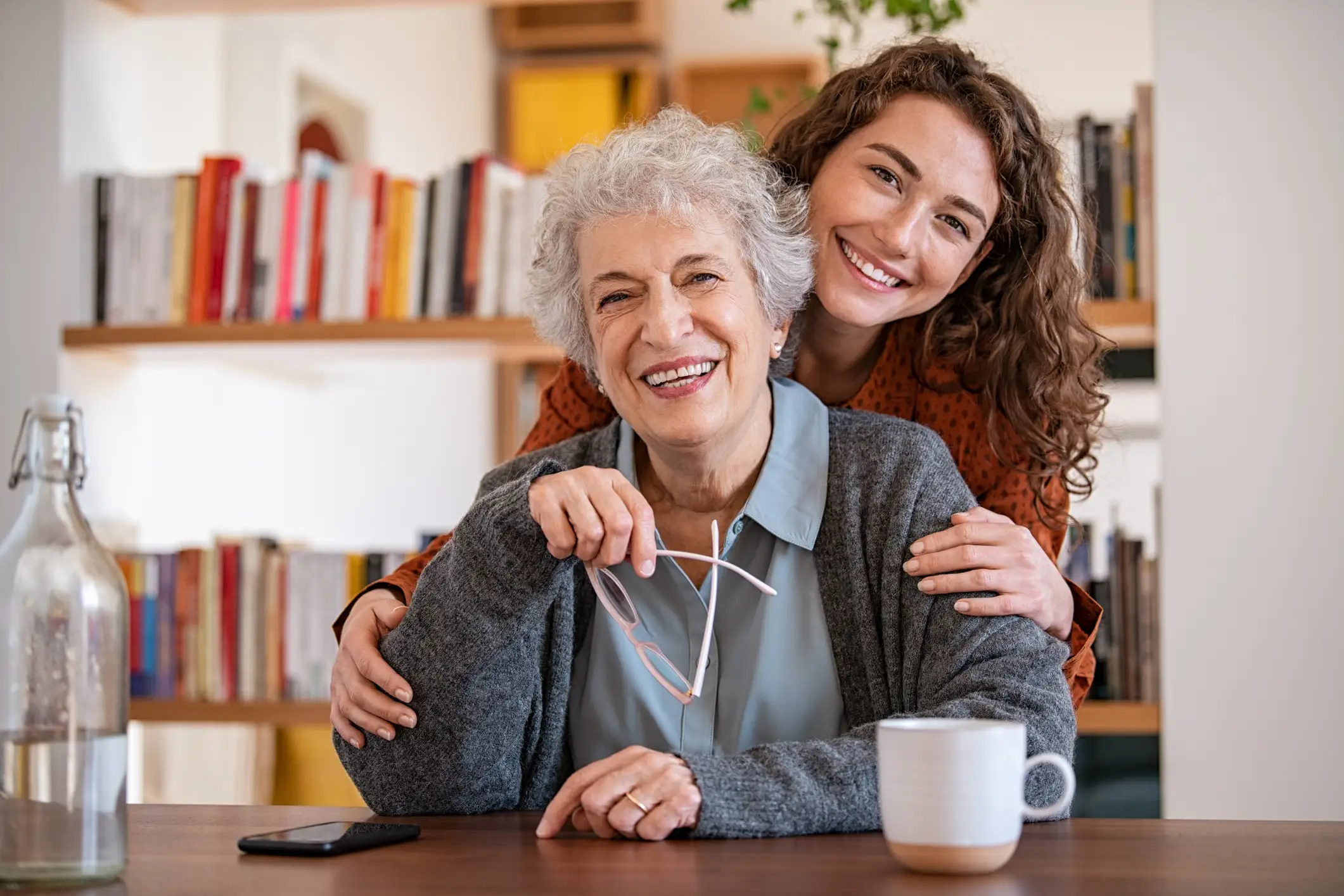 Senior woman and her adult daughter enjoying coffee together