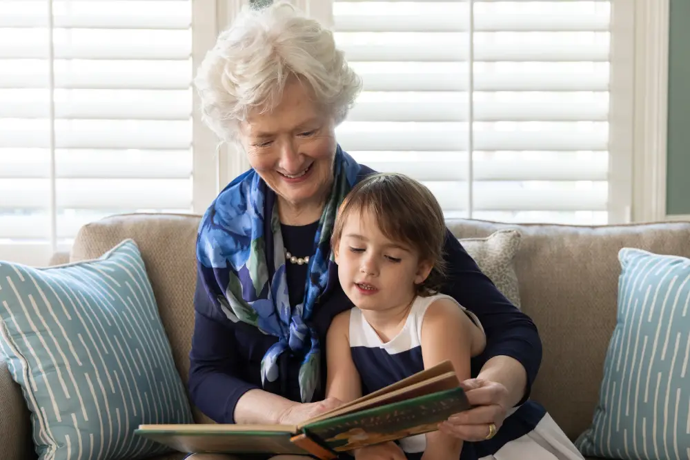 senior woman reading to her young grandchild