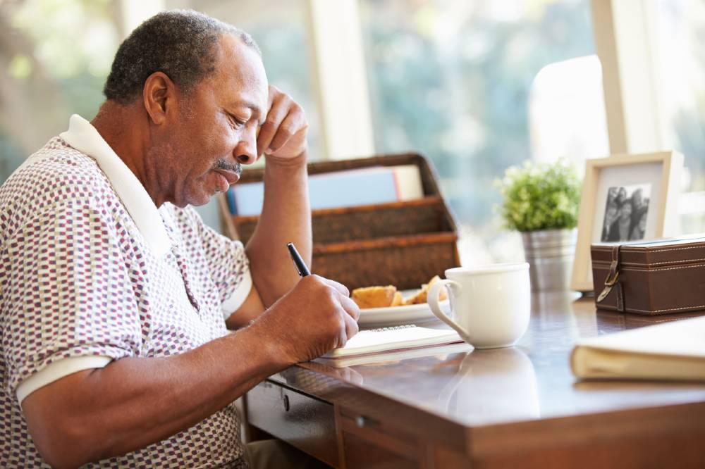 Senior man writing a letter