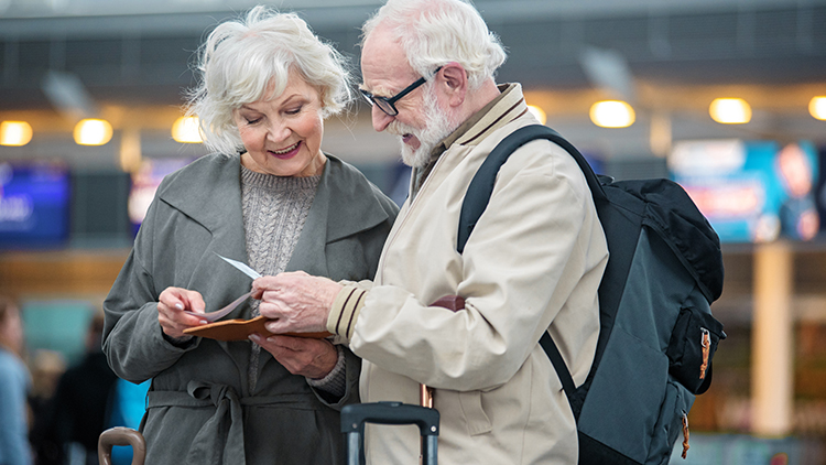 senior couple looking at tickets