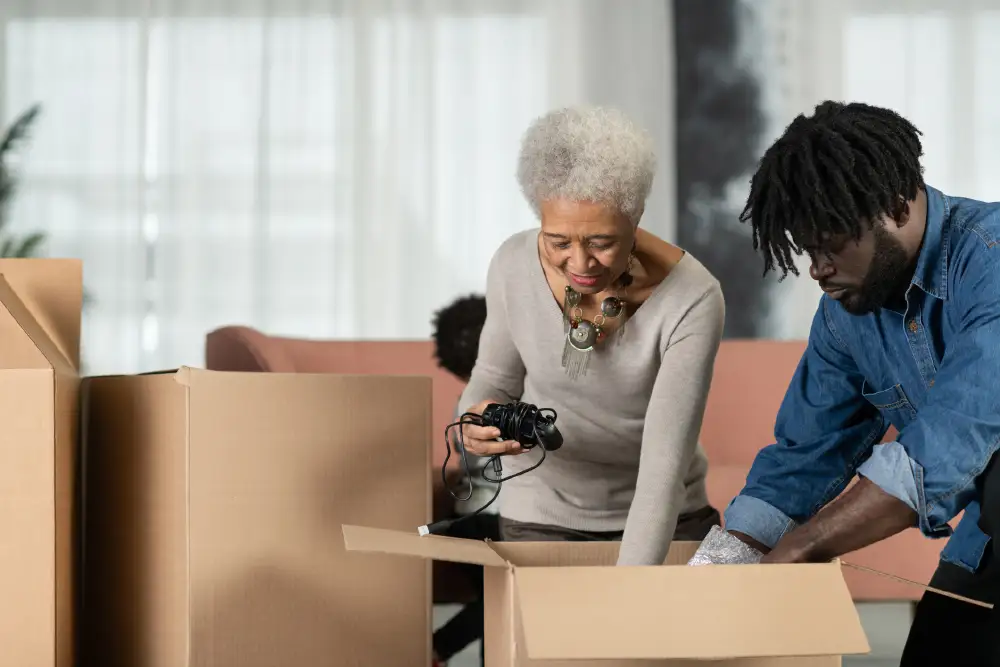 a senior woman and her adult son packing up boxes, preparing for a move