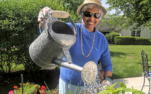 senior woman gardening outside at presbyterian homes