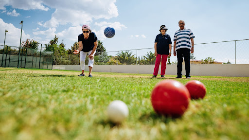 seniors playing bocce ball outside